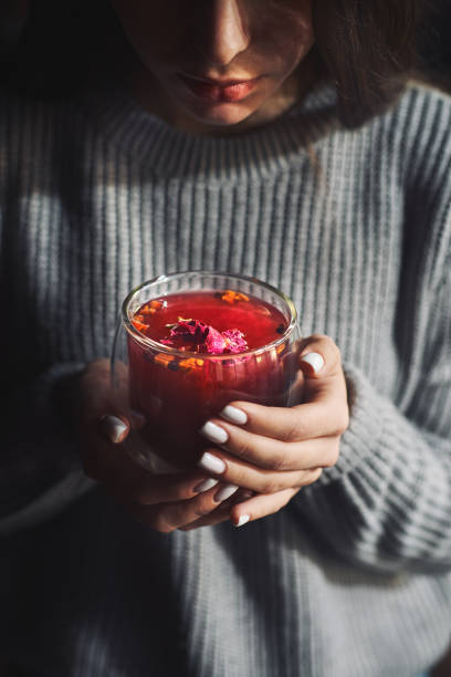 istock girl enjoying tea, focus on the cup in her hands 1361274426