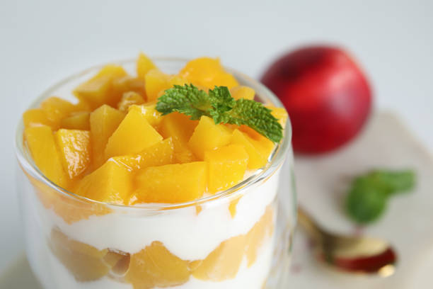 istock Tasty peach dessert with yogurt on table, closeup 1361274562