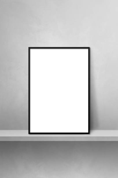 istock Black picture frame leaning on a grey shelf. 3d illustration. Vertical background 1361275363