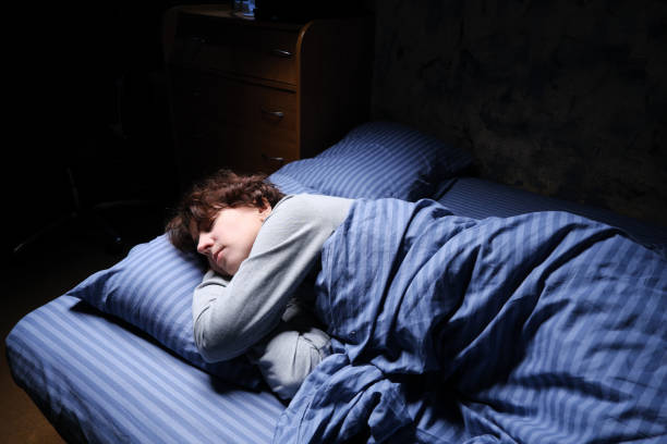 istock Mature woman is sleeping in her bed 1361278100