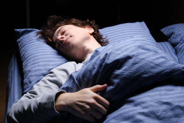 istock Mature woman is sleeping in her bed 1361278173