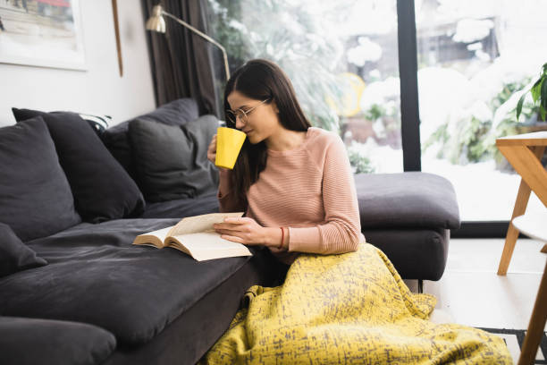 istock Girl spending a weekend afternoon reading and enjoying coffee 1361279019
