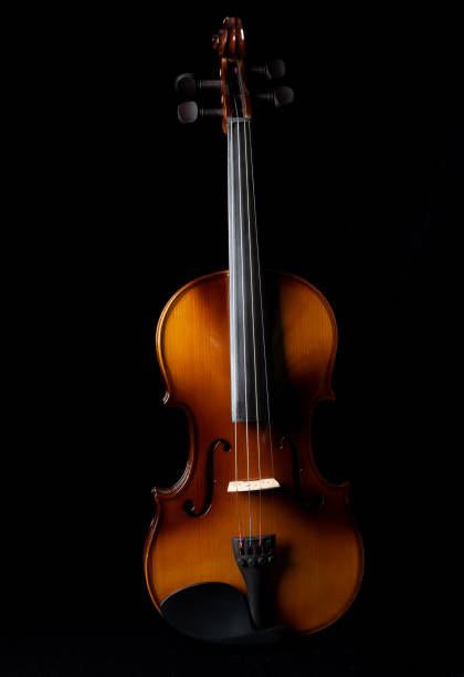 istock Light and shadows on a violin against a dark background. 1361282754