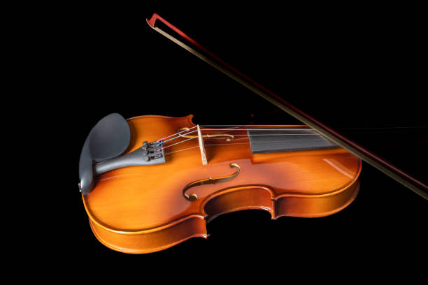 istock Silhouette of a violin and a bow on it isolated on a black background. 1361282787