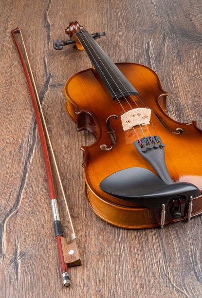 istock Violin and bow on a wooden background. 1361282967