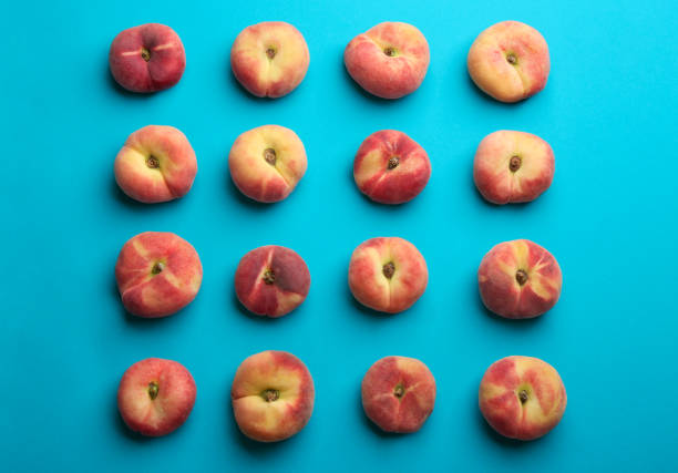 istock Fresh donut peaches on blue background, flat lay 1361284087