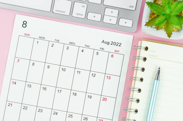 istock August 2022 calendar sheet with keyboard computer on pink background. 1361284894