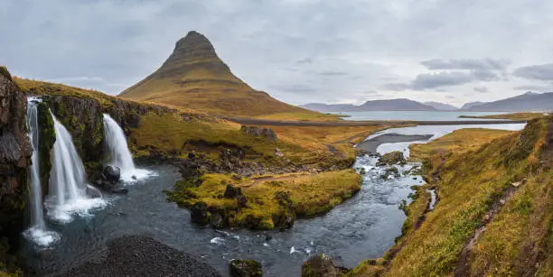 Photo of Famous picturesque Kirkjufell mountain and Kirkjufellsfoss waterfall next to Grundarfjörður at West Iceland autumn view.