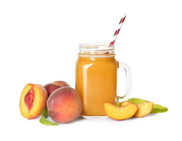 istock Natural freshly made peach juice on white background 1361287665
