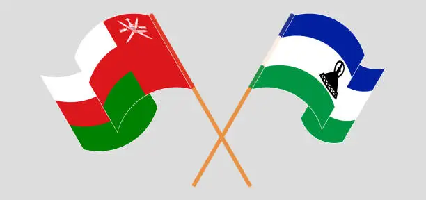 Vector illustration of Crossed and waving flags of Oman and Kingdom of Lesotho