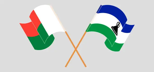 Vector illustration of Crossed and waving flags of Madagascar and Kingdom of Lesotho