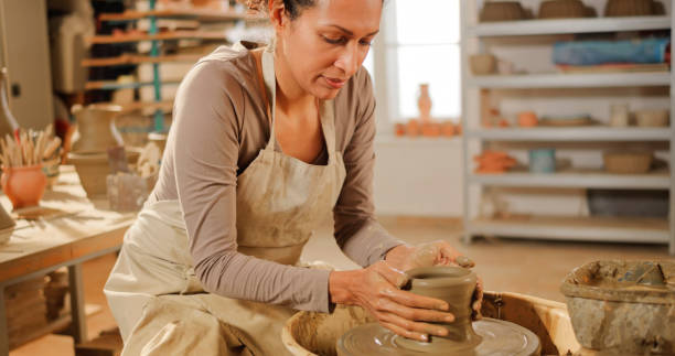 istock Woman making vase on a potter's wheel 1361290654