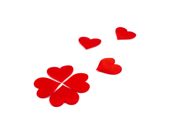 Red silk valentine hearts. A symbol of love handmade. Love and togetherness concept. Design element for holiday, greeting card, postcard and banner.