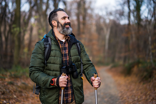 Image of man enjoys hiking in  nature.