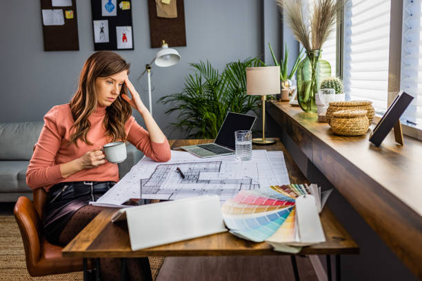 istock Exhausted businesswoman having a headache in modern office. 1361295719