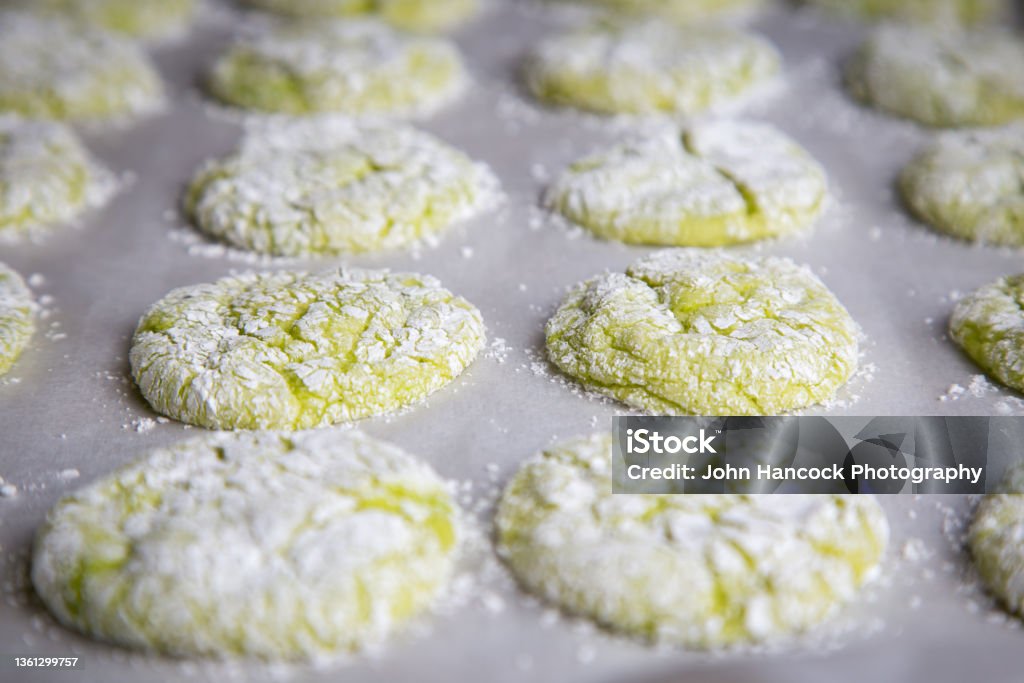 Grinch holiday cookies with powered sugar and red hearts Green home made cookies resembling the holiday movie "The Grinch" that are green with a small red heart. Baked Stock Photo