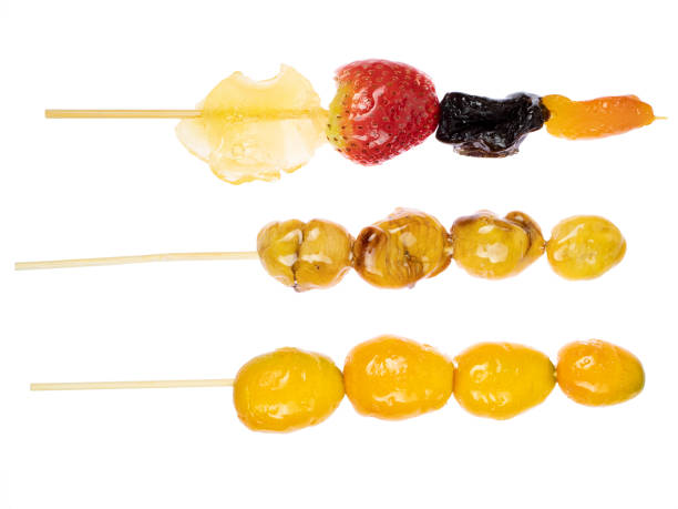 Strawberry and orange Tanghulu or Tang Hulu. It is a fruit dipped with sugar coating on a skewer. It is a traditional Northern Chinese snack.
