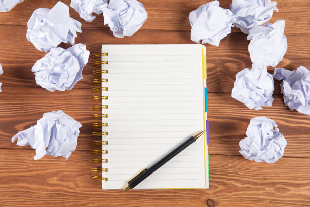 istock wads of papers on the desktop and notepad 1361304114