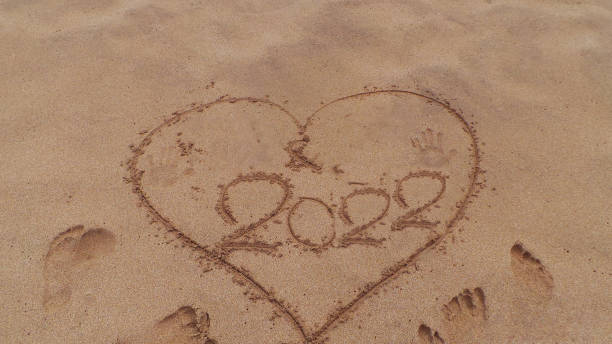 istock heart drawing on the sand happy new year 2022 - 1361304559