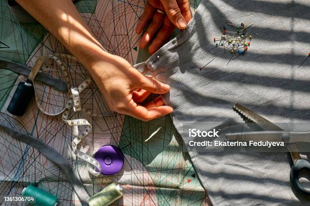 Woman Is Sketching Pattern On A Linen Fabric Seamstress Basting And Sewing In A Small Studio Sartorial Clothes Fashion Studio Tailoring Handmade Clothing Concept Slow Fashion Conscious Consumption Stock Photo - Download Image Now