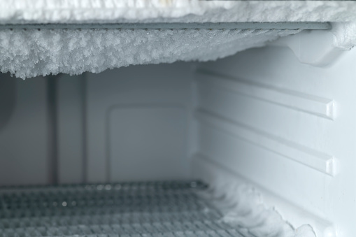 Close up of ice on the empty freezer walls.