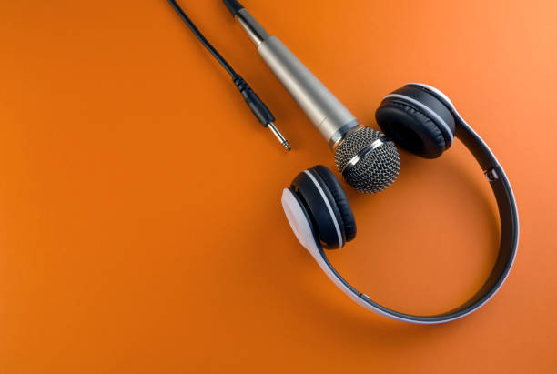 headphones and microphone on an orange background