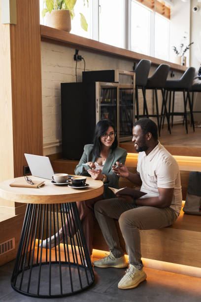 istock Two Business People Working in Cafe 1361314091