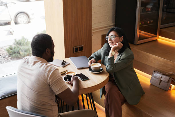 istock Young Business People in Cafe on Break 1361314097
