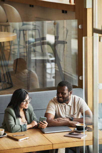 istock Two Business People in Cafe 1361314108