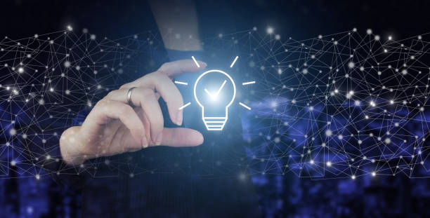 istock Innovation, brainstorming, inspiration and solution concepts. Hand hold digital hologram light bulb sign on city dark blurred background. Network bright idea with light bulb 1361316268