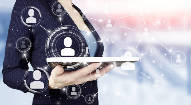istock Social media concept. Communication network. Hand hold white tablet with digital hologram Human, Leader sign on light blurred background. HR Human resources, peoples relation organisation structure. 1361316274