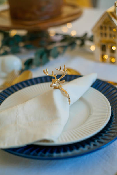 istock Stylish light Christmas table setting with golden cutlery. Festive feasts. Decorations on the New Year's table. 1361320117