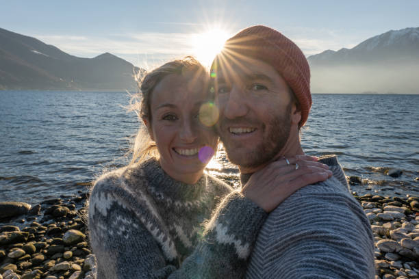 istock Young couple taking cool selfie by the lake 1361320209