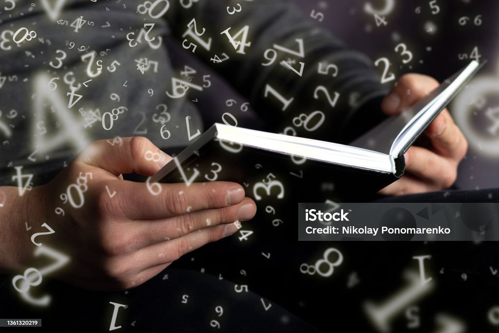 numerology, a man holds an open book in his hands, surrounded by numbers Numerology Stock Photo