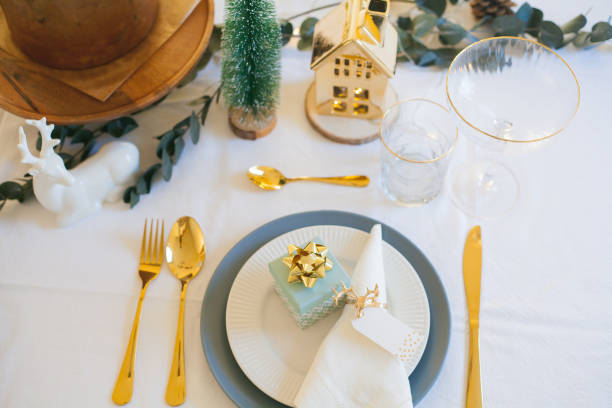 istock Stylish light Christmas table setting with golden cutlery. Festive feasts. Decorations on the New Year's table. 1361321437