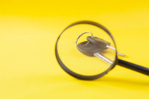 istock magnifier and keys on a yellow background 1361321532