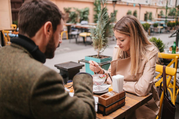 Lunch talk A young couple talking while lunch and laughing hard eating chia seeds stock pictures, royalty-free photos & images