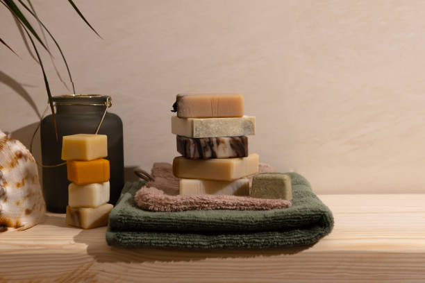 Organic solid hair shampoo and handcrafted soap with all natural plant-based essential oils on a wooden bathroom shelf.
