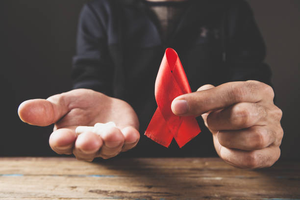 istock holding pills and red tape 1361328686