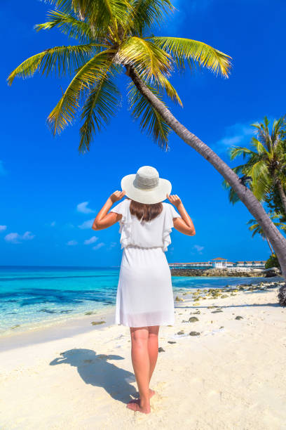 Woman standing on the beach stock photo