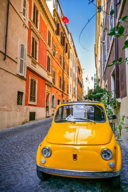 A beautiful and conserved 1969 model of the famous Fiat 500 parked in an alley in the ancient Monti district, in the historic heart of Rome. This vintage car is a symbol of Italian design and industry also present in the MoMA museum in New York. The Monti district is a popular and multi-ethnic quarter much loved by the younger generations and tourists for the presence of trendy pubs, fashion shops and restaurants, where you can find the true soul of the Eternal City. This district, located between the Esquiline Hill and the Roman Forums, is also rich in numerous neoclassical palaces, Baroque-style churches and archaeological remains of the Ancient Rome. In 1980 the historic center of Rome was declared a World Heritage Site by Unesco. Image in high definition format.