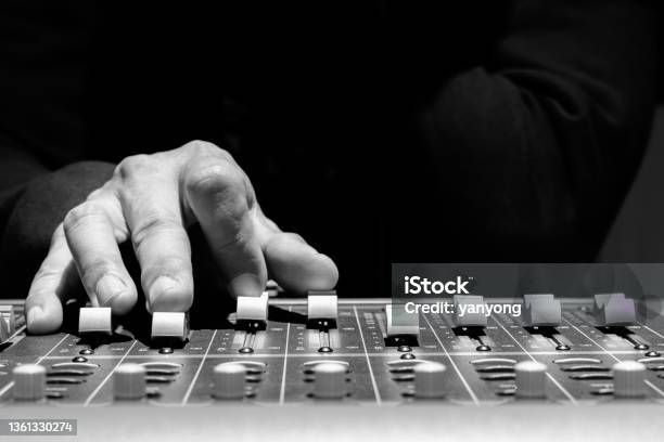Close Up Sound Engineer Hands Adjusting Control Surface Mixer In Recording Broadcasting Studio Stock Photo - Download Image Now