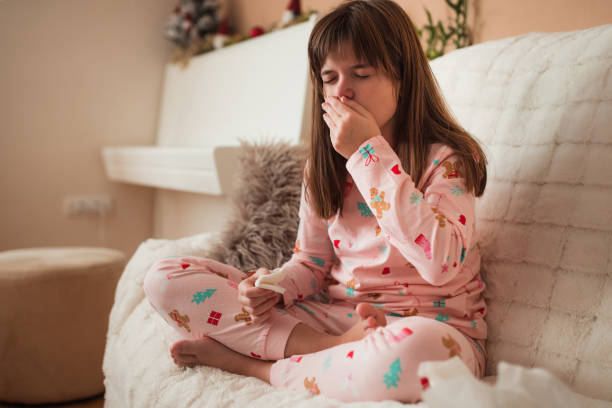 istock Girl having a fever and sneezing 1361333421