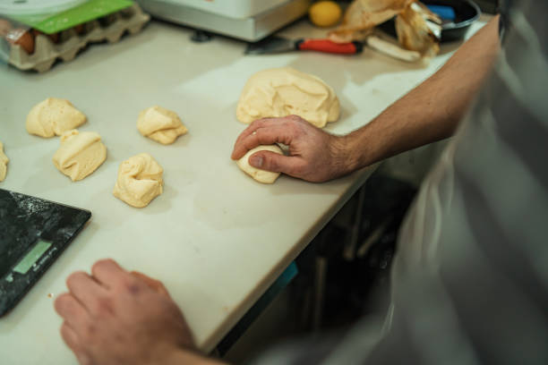istock Man kneading bread, detail of hands 1361335182