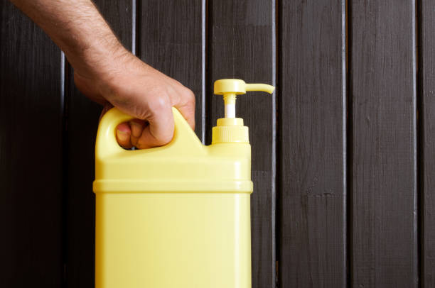 istock A man's hand holds a yellow plastic canister with a pump dispenser. A container with a cleaning disinfectant liquid. Sanitary cleaning and disinfection concept 1361337403