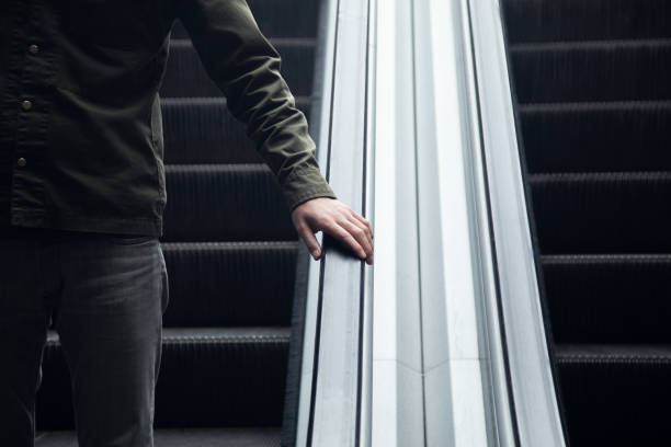 istock a man walking down the steel escalator in the subway 1361337616