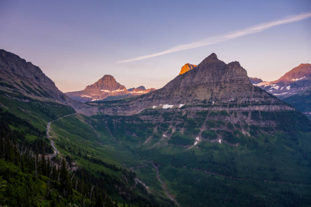 istock Green Slopes Below Rugged Mountains at Logan Pass 1361340603