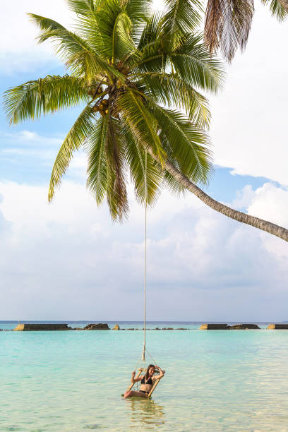 istock Woman on swing at hammock 1361345097