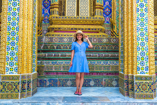 Woman traveler at  Wat Phra Kaew (Temple of the Emerald Buddha) and Grand Palace and  in Bangkok in a summer day