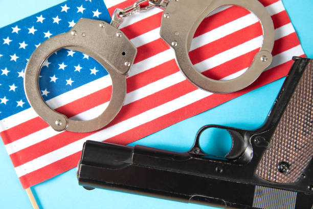 istock america flag, handcuffs and pistol 1361352001
